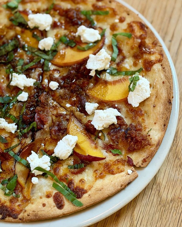 A summer cracker crust, peaches and goat cheese