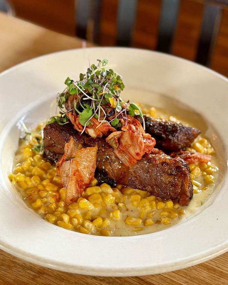 Glazed pork belly over creamed corn