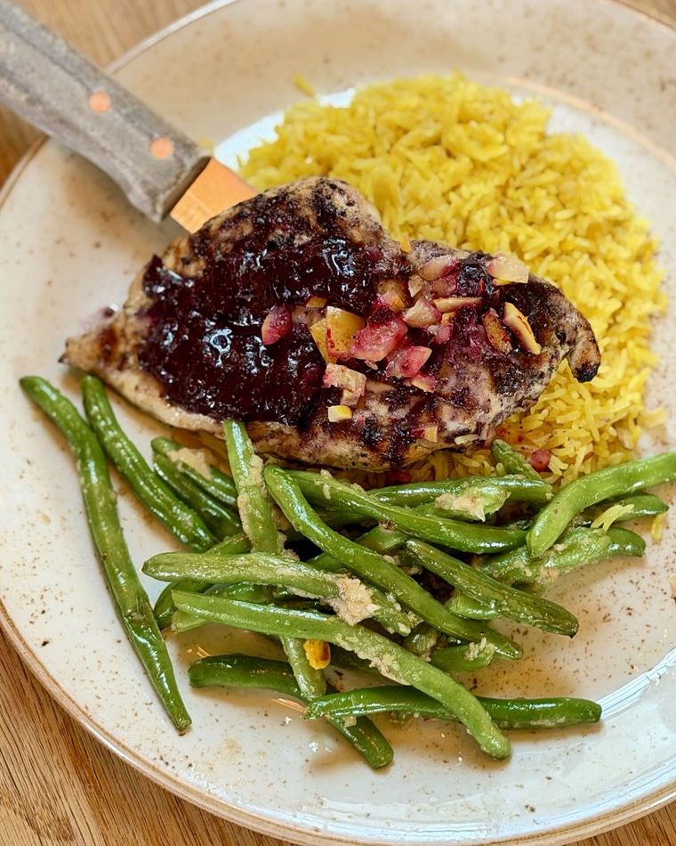 Steak over almond rice pilaf with green beans
