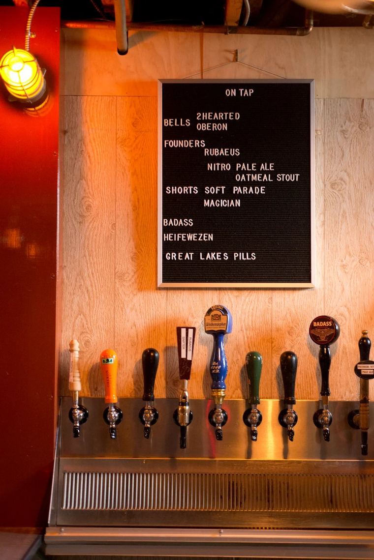 The tap list chalkboard behind the bar